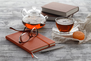 Note to day plans with cup of tea on table