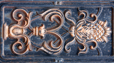 antique bronze bas-relief of the metal as a background
