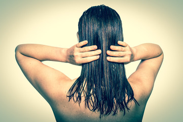 Attractive woman applying conditioner on her hair