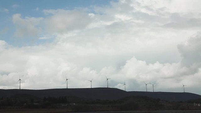 Wind Turbines turn in windy cloudy and rainy weather