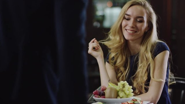 man coming to a nice young girl in cafe and toasting