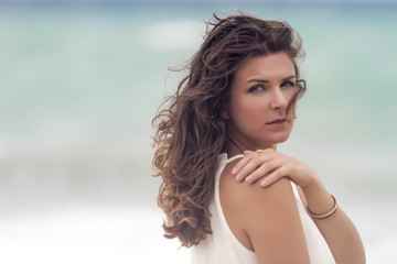 Portrait of a young attractive and beautiful woman in front of the beach. Close up.