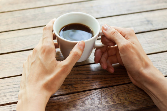 Hand with cup of coffee