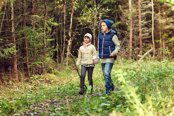 Naklejka na ściany i meble two happy kids walking along forest path