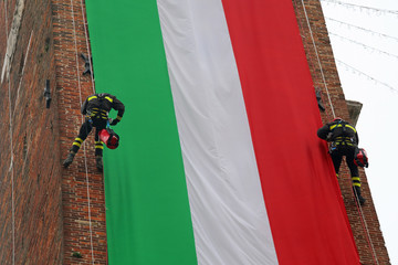 Italian very brave fearless firefighters climb the old tower wit