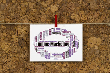 Online Marketing word cloud on business card pinned up on cork board