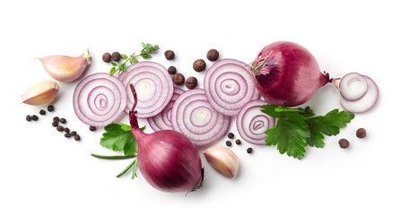 red onions, garlic and various spices on white background