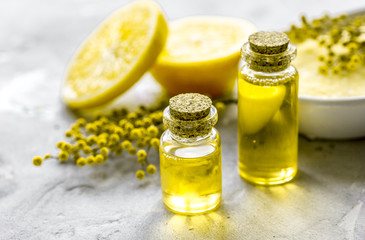 Natural cosmetic with bath salt and organic oil on gray background