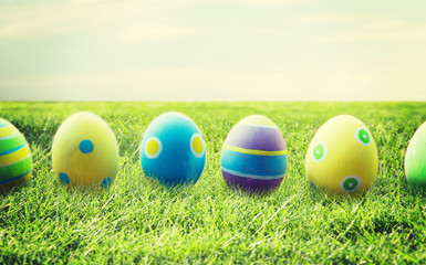 close up of colored easter eggs on wooden surface