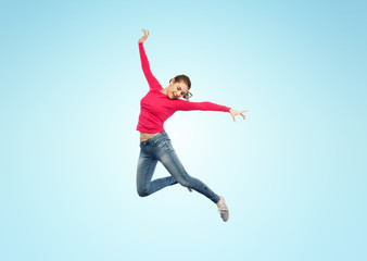 Fototapeta na wymiar happy young woman jumping in air or dancing