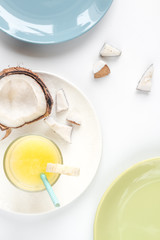 cocktail with coconut on white background top view