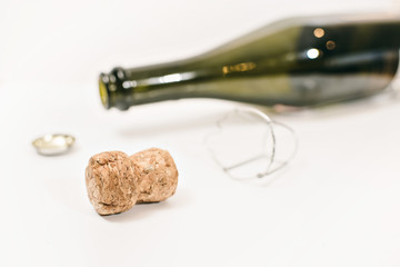 the end of the event (an empty champagne bottle and cork on white background)