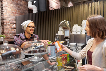 happy woman buying chai latte drink at vegan cafe