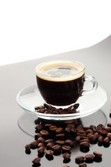Coffee cup and coffee beans on table