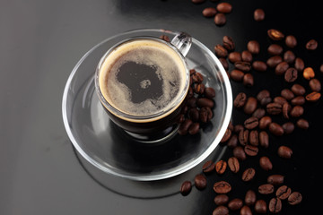 Coffee cup and coffee beans on table