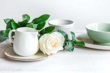 ceramic tableware with flowers on white background