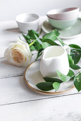 ceramic tableware with flowers on white background