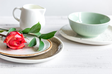 ceramic tableware with flowers on white background