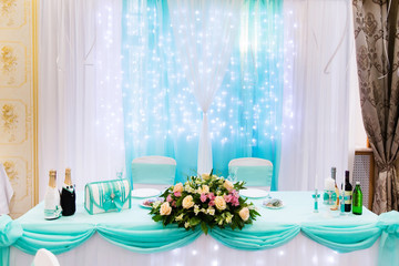 Wedding table in restaurant with flower composition. Wedding decoration
