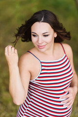 Fototapeta premium Portrait of a young smiling pregnant woman