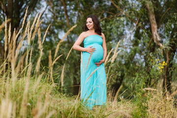 Beautiful pregnant woman outdoors