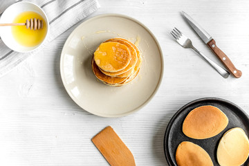 cooked pancake on plate top view at wooden background