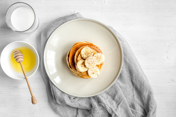 cooked pancake on plate top view at wooden background