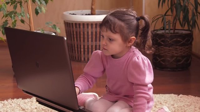 A child at home with a laptop. Full hd