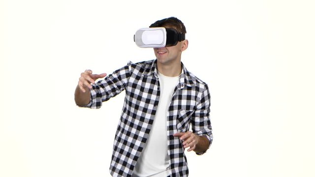 Man in mask of virtual reality on head. White background