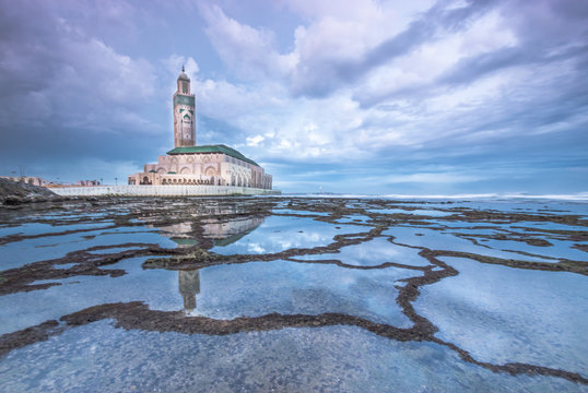 Reflection of Hassan II Mosque in the calm ocean - Casablanca  Morocco -  in the early morning