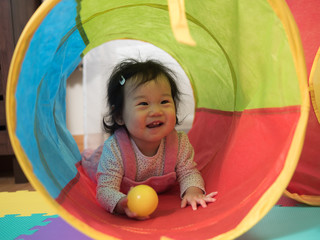 Obraz premium cute smiling baby girl play toy at home