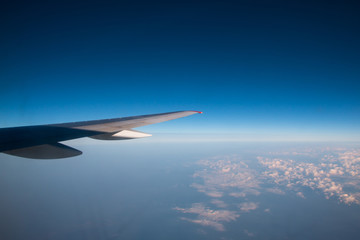 Fototapeta na wymiar The wing of an airplane flying in the sky