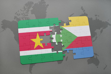 puzzle with the national flag of suriname and comoros on a world map