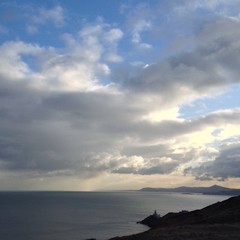 lighthouse in front of the ocean
