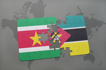 puzzle with the national flag of suriname and mozambique on a world map