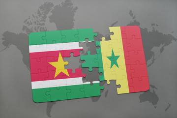 puzzle with the national flag of suriname and senegal on a world map