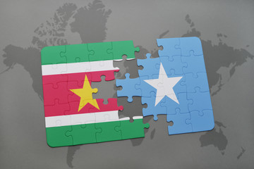 puzzle with the national flag of suriname and somalia on a world map
