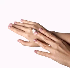 Poster Beautiful young woman hands with cream, isolated on white. © Maxim