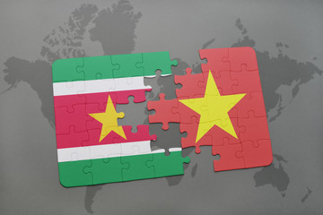 puzzle with the national flag of suriname and vietnam on a world map
