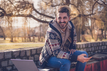 Obraz premium Young Man With Laptop Working 