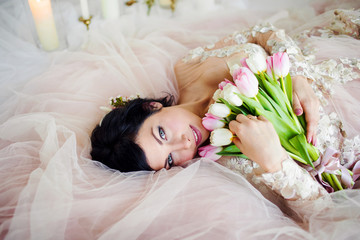 Obraz na płótnie Canvas Beautiful girl in a dress with a bouquet