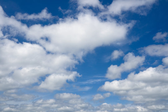 White clouds flying against blue sky. Blue sky with clouds over horizon.