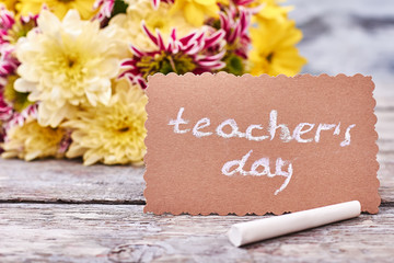 Chrysanthemum, piece of chalk, card. Wonderful flowers for a teacher.