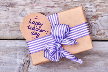 Congratulatory card and wrapped box. Celebrate national holiday with teacher.