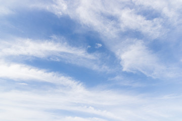Transparent blue sky with clouds and atmospheric afternoon.