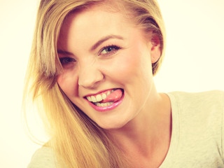 Naklejka premium Funny blonde woman sitcking tongue out