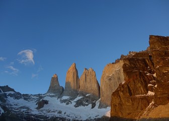 Sunrise in Patagonia as early sun lights up the granite towers in Torres del Paine National Park. 