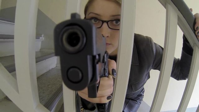 women officer holding gun.