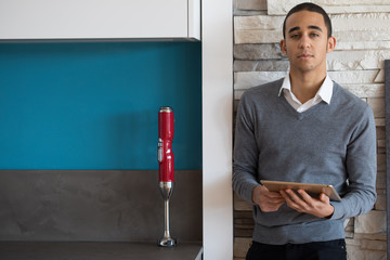 man with a tablet in a kitchen