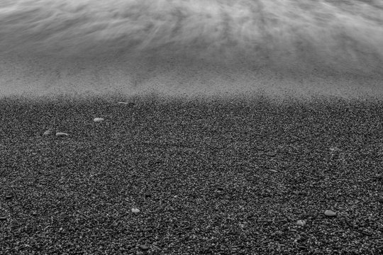 Fototapeta Wave Crashing Beach Black White Vintage Ocean wave crashing towards beach coastline in black white vintage tone